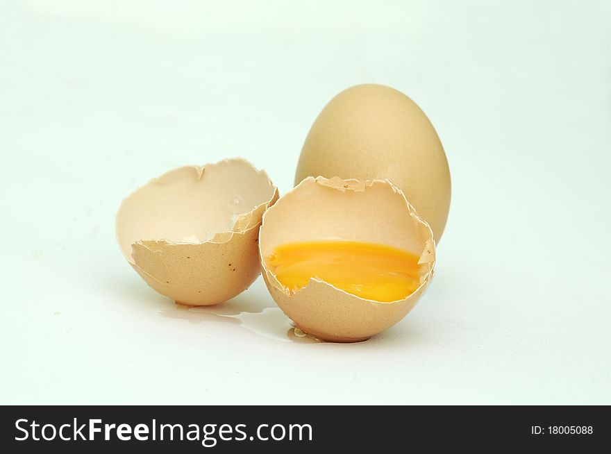Raw broken eggs on white background. Raw broken eggs on white background.