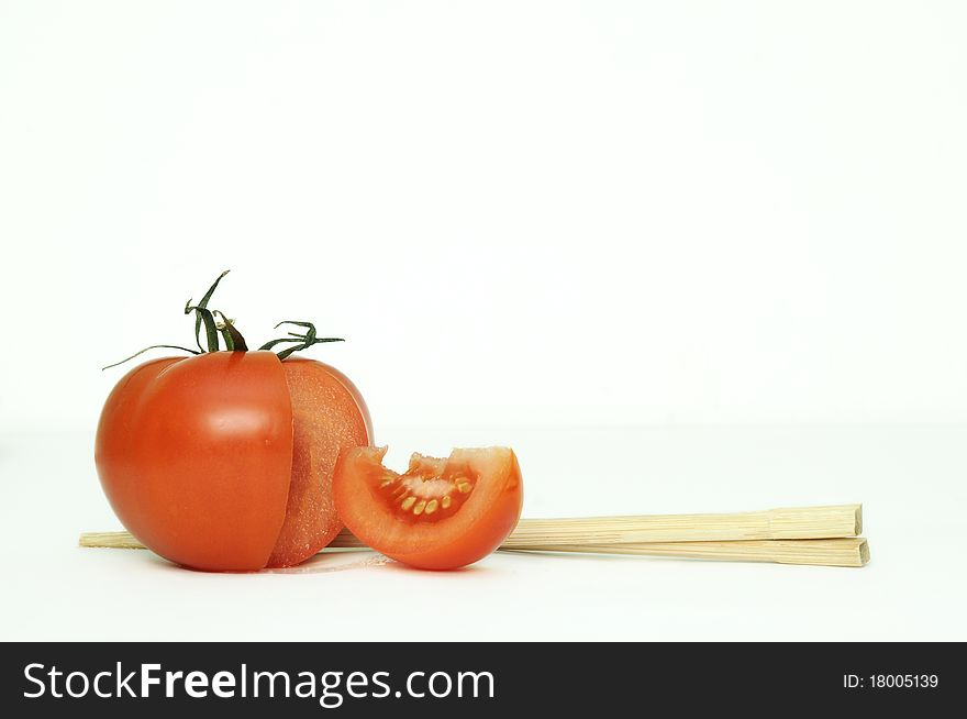 Tomatoe and chopsticks on white backgraund. Tomatoe and chopsticks on white backgraund.