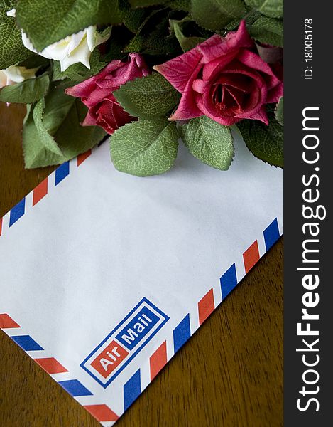 Blank airmail envelope and bouquet of roses. Blank airmail envelope and bouquet of roses