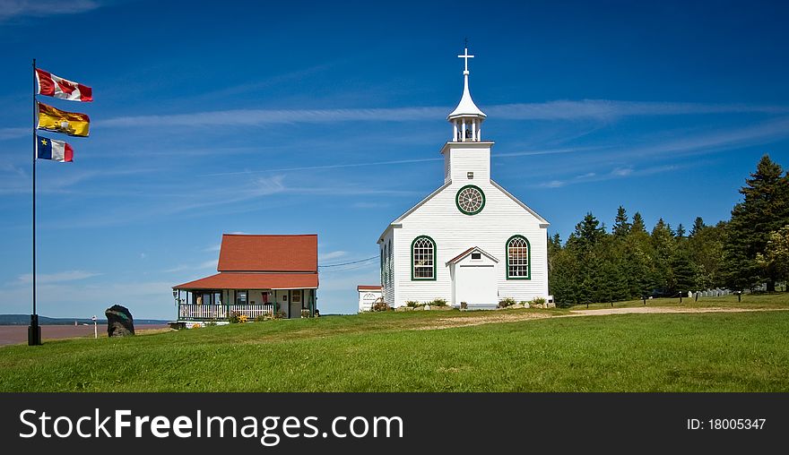 Small white wooden rural church against a background of blue summer sky. Small white wooden rural church against a background of blue summer sky.