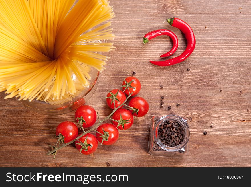 Composition of tow kind of pepper,  italian pasta and tomato cherry. Composition of tow kind of pepper,  italian pasta and tomato cherry
