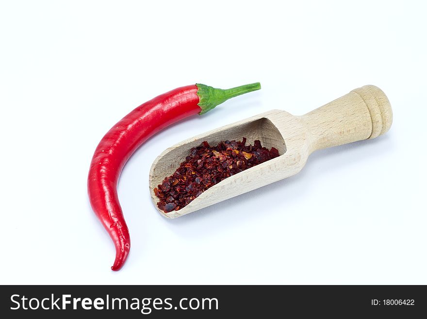 Fresh and crushed red pepper on white background