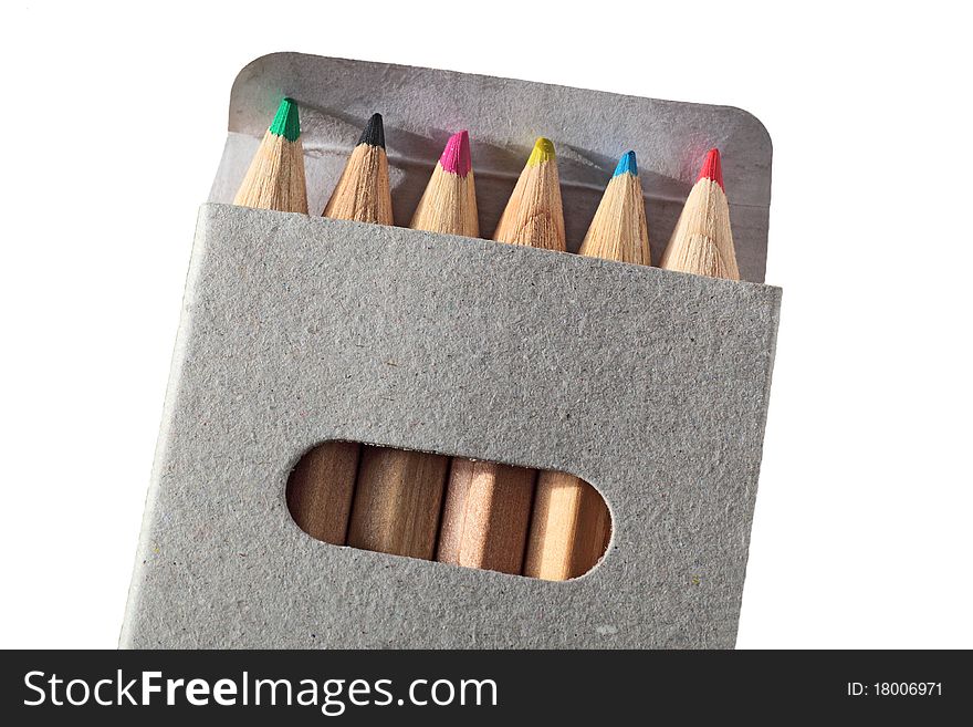 Wooden color pencils in a gray carton box isolated in white