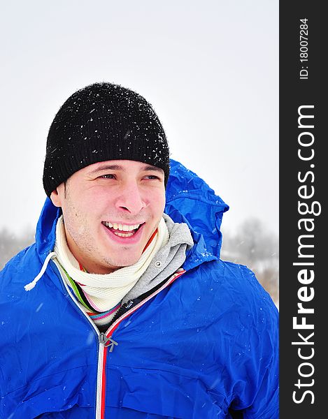 Image of a cheerful smiling man taking a walk outdoors in winter time. Image of a cheerful smiling man taking a walk outdoors in winter time