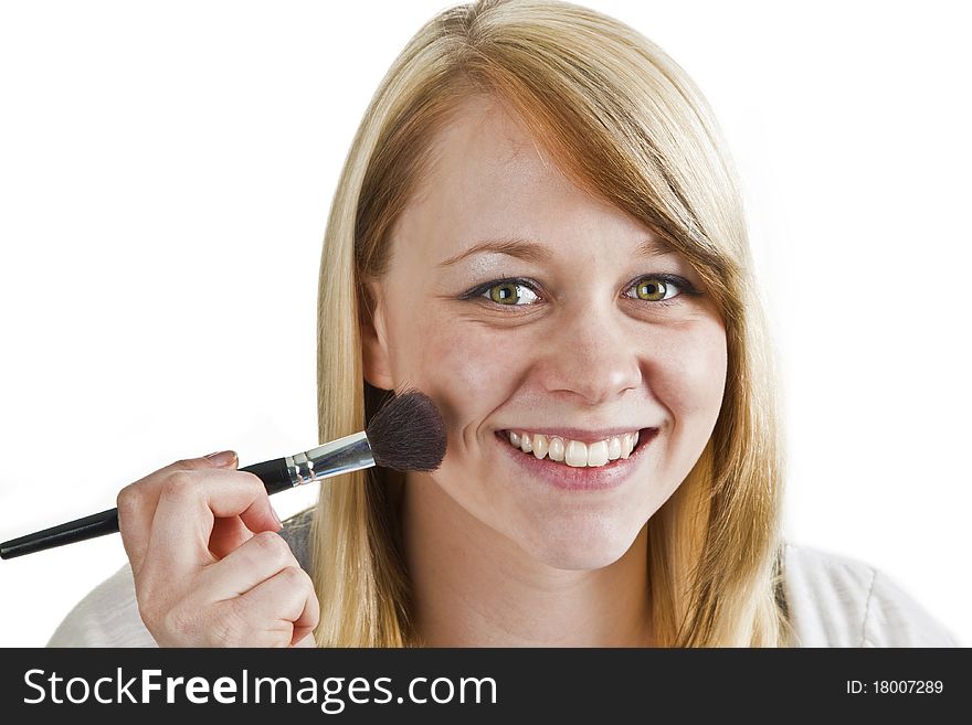 Attractive young woman applying blusher - isolated on white. Attractive young woman applying blusher - isolated on white