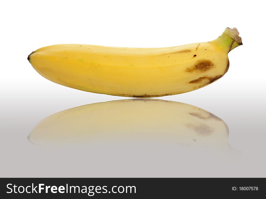 Closeup of single ripe banana isolated on white background.