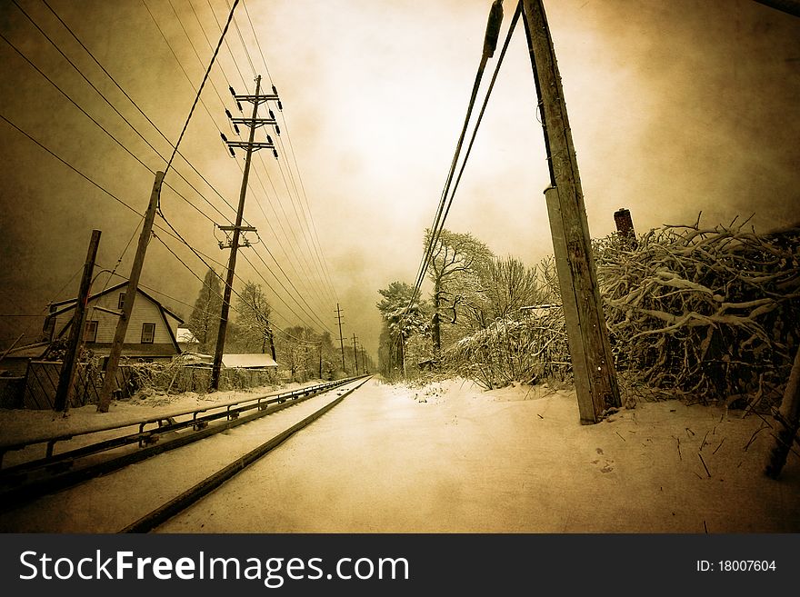 A textured, vintage looking image of a railroad crossing covered by snow. A textured, vintage looking image of a railroad crossing covered by snow