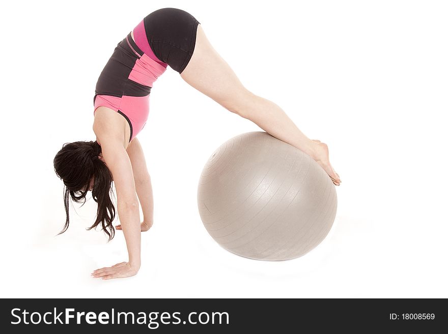 A woman is exercising with a big ball. A woman is exercising with a big ball.