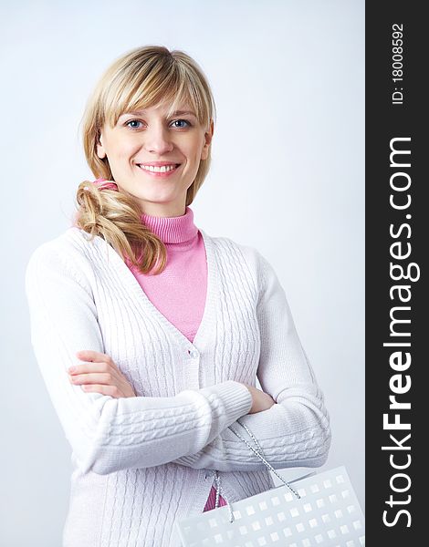 Portrait of attractive blonde woman with shopping bag on the white background. Portrait of attractive blonde woman with shopping bag on the white background