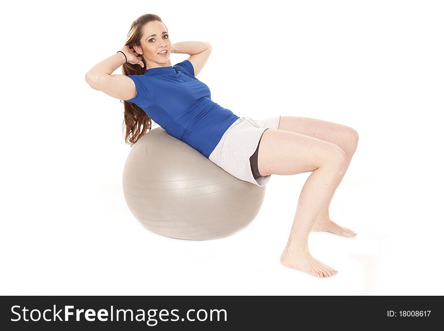 A woman is leaning back on a big ball. A woman is leaning back on a big ball.