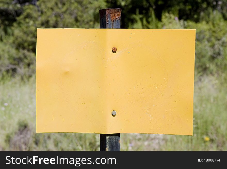 Metal empty yellow sign in the countryside