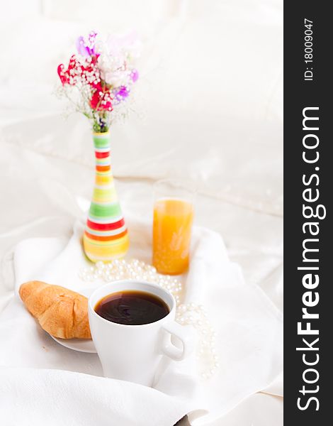 Cup of coffe and flower in vase on tray. Cup of coffe and flower in vase on tray