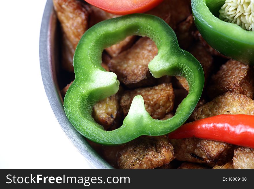 Closeup shot of capsicum ring on fried potatoes.