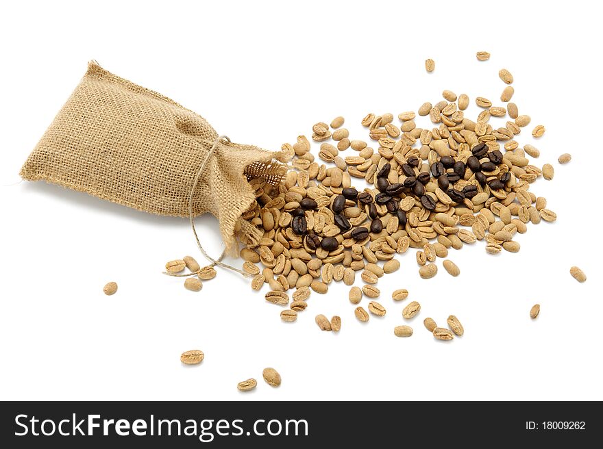 Roasted beans spelling the word coffee with the background of unroasted coffee beans. Isolated over white