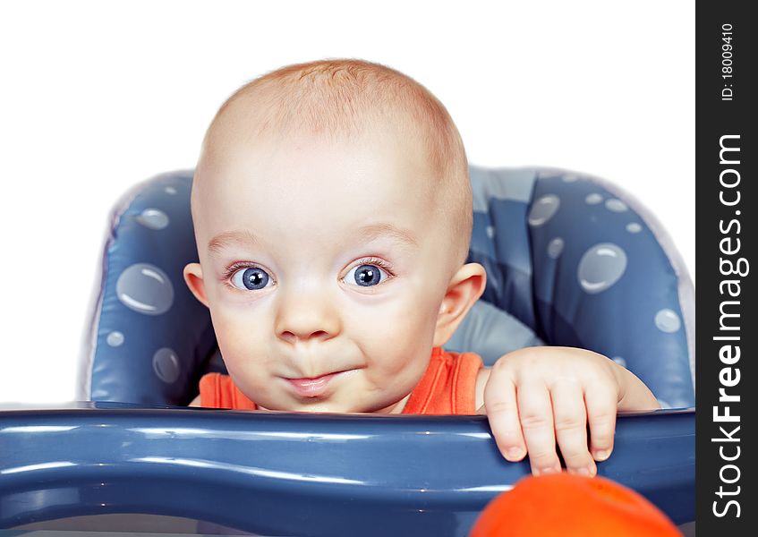 Small beautiful baby boy in a baby chair isolated on white