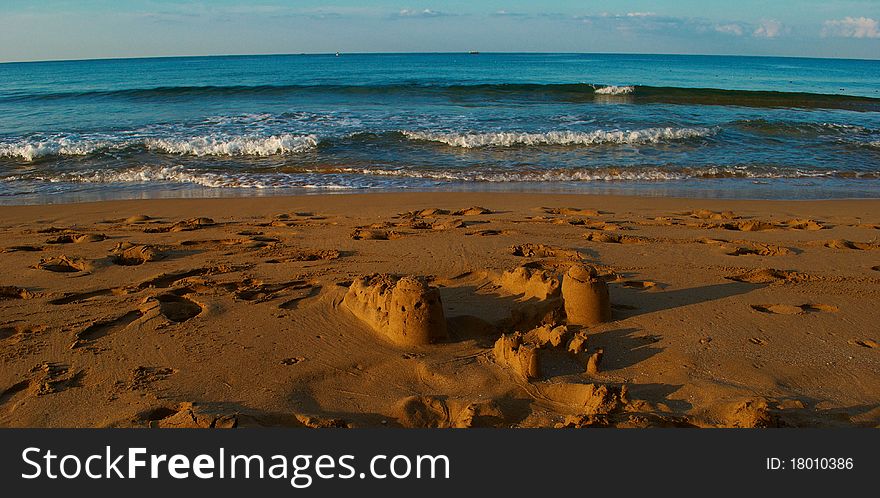 Morning deserted beach and constructions from sand