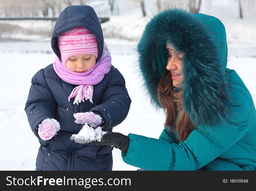 Mother and  kid having fun outdoors on beautiful winter day. Mother and  kid having fun outdoors on beautiful winter day