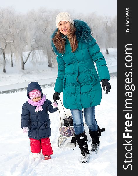 Mother And  Kid Having Fun Outdoors On  Winter Day