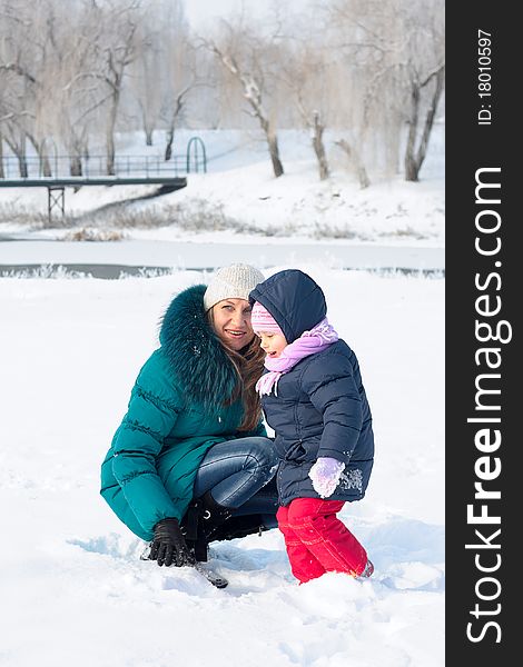 Mother And  Kid Having Fun Outdoors On  Winter Day