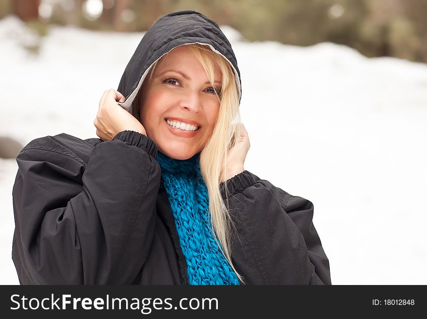 Attractive Woman Having Fun in the Snow on a Winter Day.