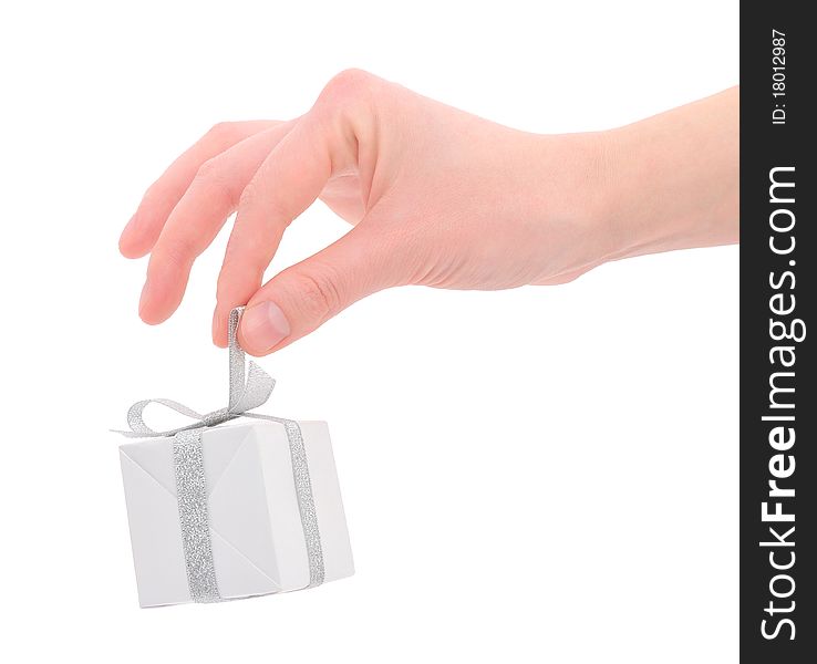 Woman's hand with a small white gift box with silver ribbon isolated on white background. Woman's hand with a small white gift box with silver ribbon isolated on white background.