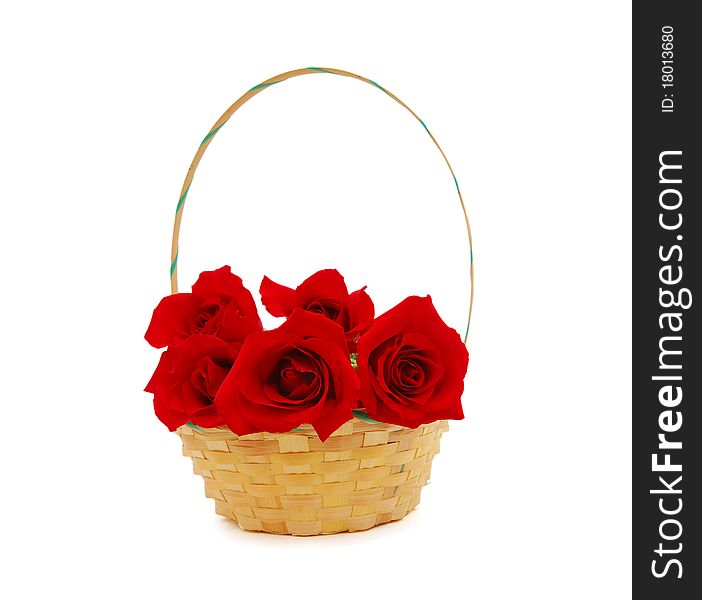 Red roses lay in a basket. It is