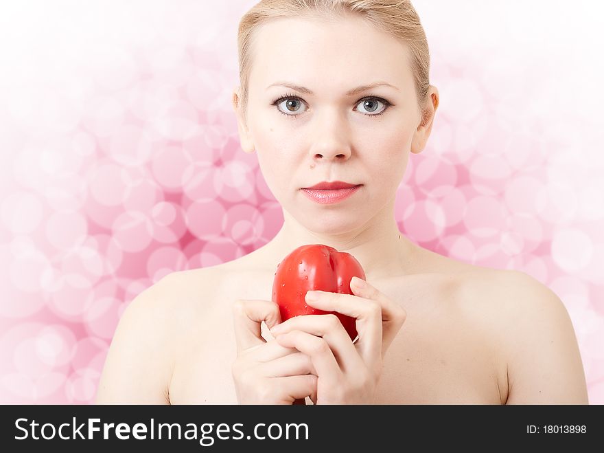 Beautiful sexy young woman holding a red sweet pepper. Beautiful sexy young woman holding a red sweet pepper.