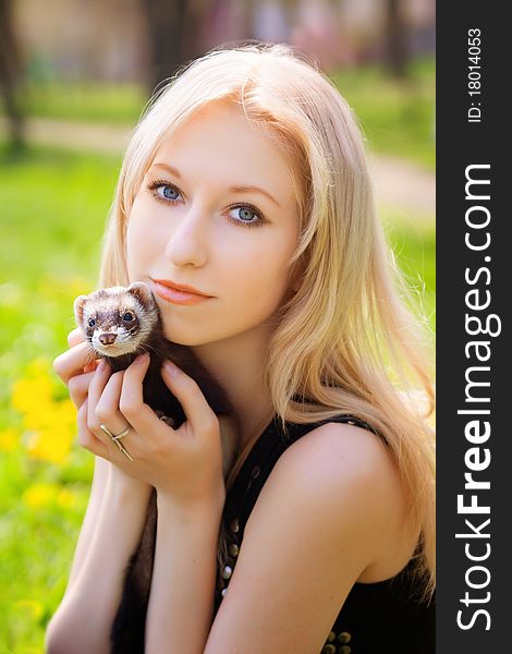 Portrait of the girl with a domestic polecat on hands. Portrait of the girl with a domestic polecat on hands
