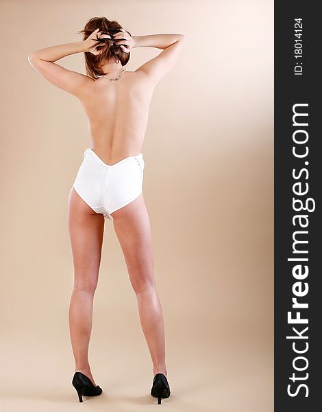 Model pose wearing white one piece that is undone. Model pose wearing white one piece that is undone.