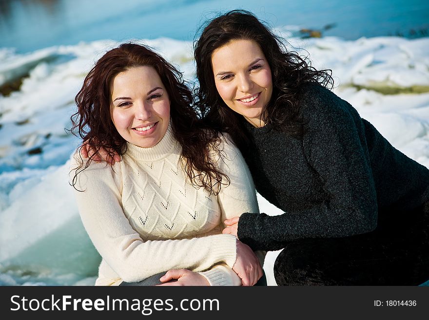 Girls twins near river in winter