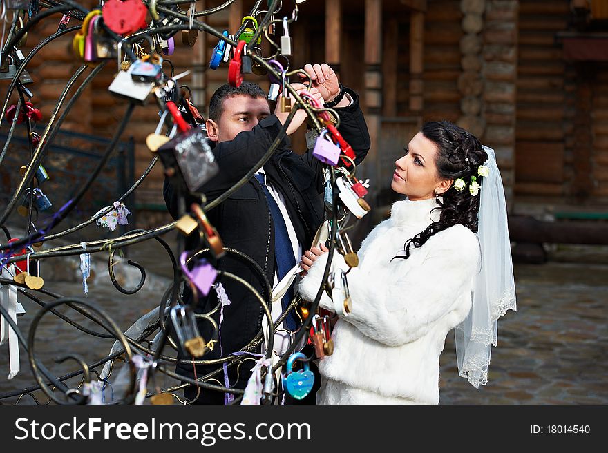 Happy Bride And Groom Near Symbol Metal Tree