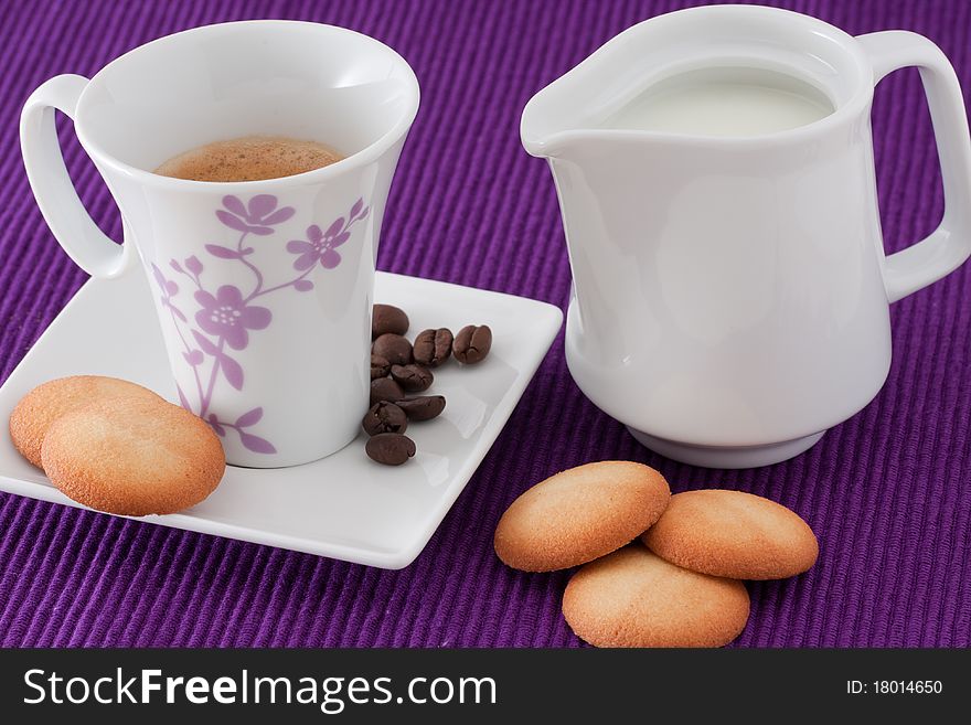 An elegant cup of coffee with milk and biscuits. An elegant cup of coffee with milk and biscuits