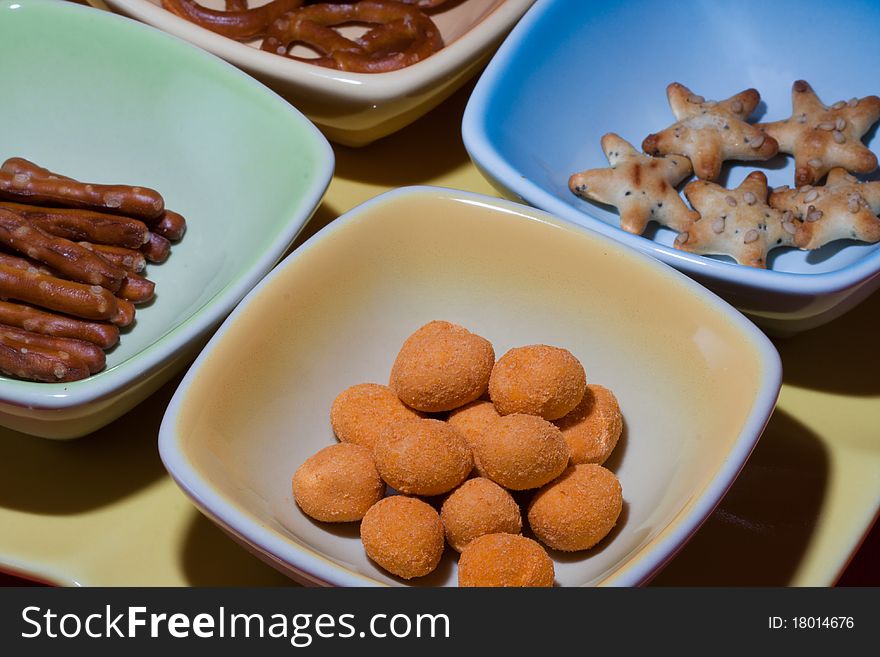 Mixed snacks and appetizers divided by small trays. Mixed snacks and appetizers divided by small trays