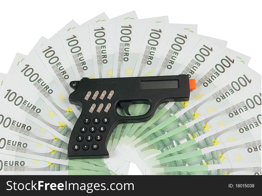 Calculator in the form of a pistol lying on the euro. Calculator in the form of a pistol lying on the euro