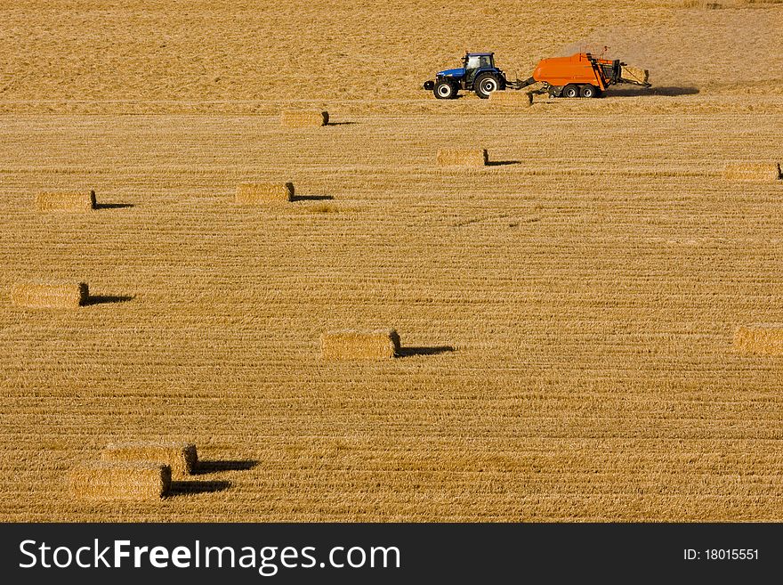 Farmer with tractor and bales