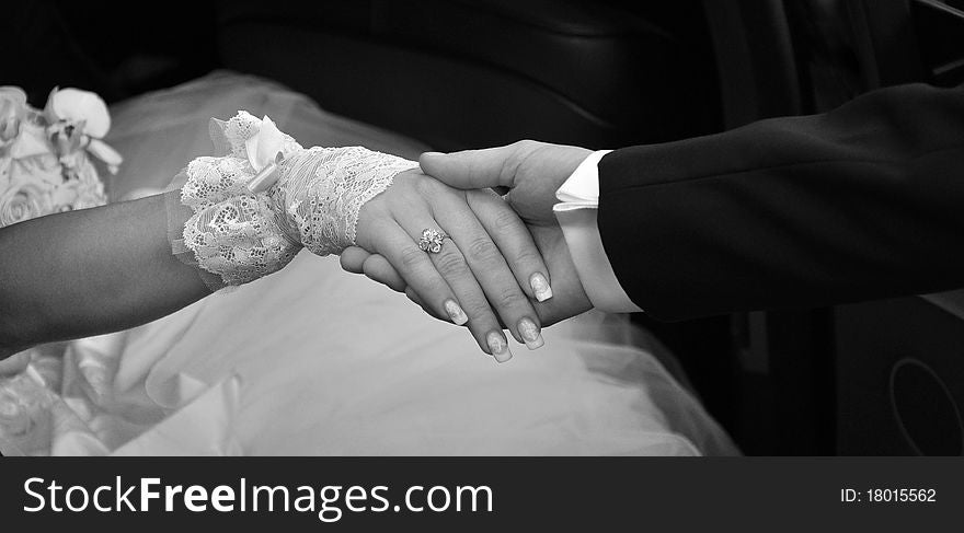 Image of hands the bride and groom in black and white. Image of hands the bride and groom in black and white
