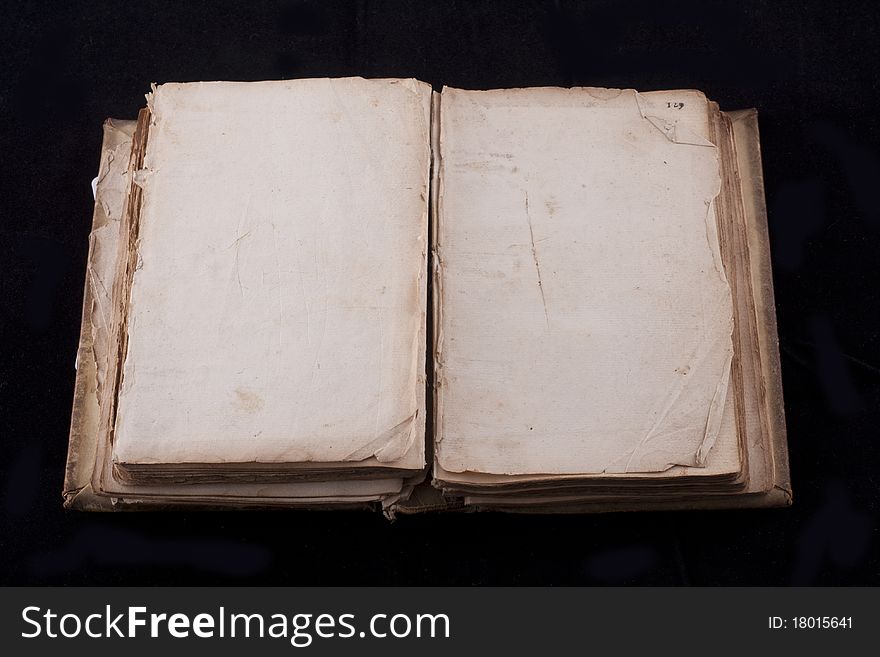 Ancient book, almost 300 years, opened on two blank sheets isolated on black