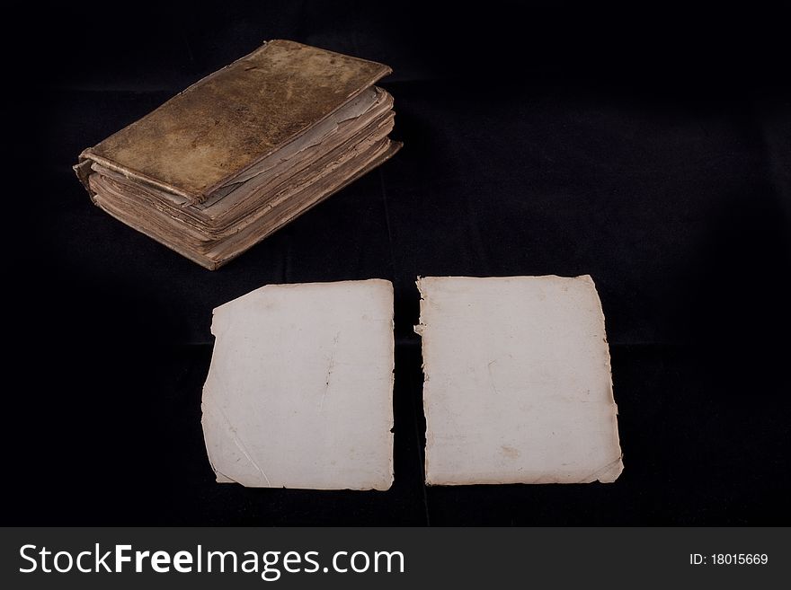 Ancient book, almost 300 years, opened on two blank sheets isolated on black