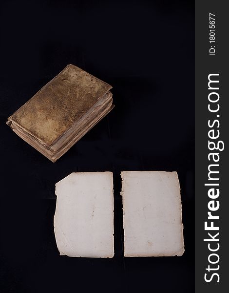 Ancient book, almost 300 years, opened on two blank sheets isolated on black