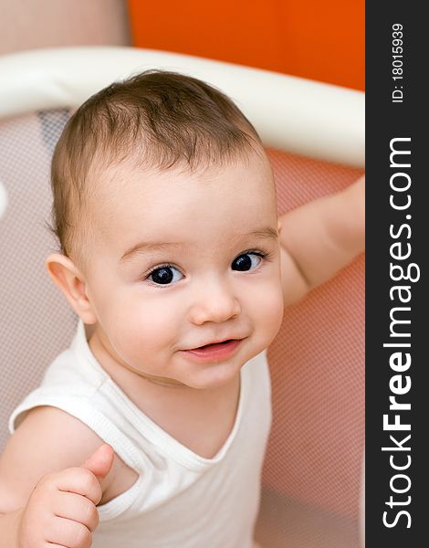 Fun caucasian smiling baby in manege. Fun caucasian smiling baby in manege