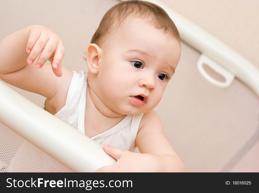 Cute caucasian baby playing in manege. Cute caucasian baby playing in manege