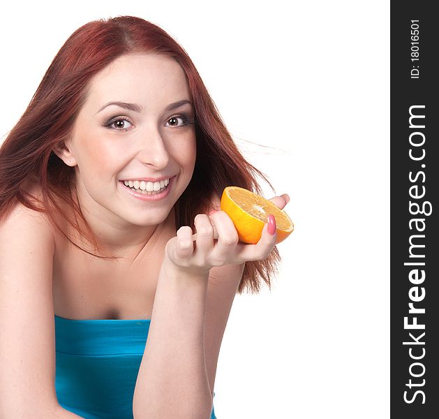 A beautiful redhead woman holdind a half of orange. A beautiful redhead woman holdind a half of orange