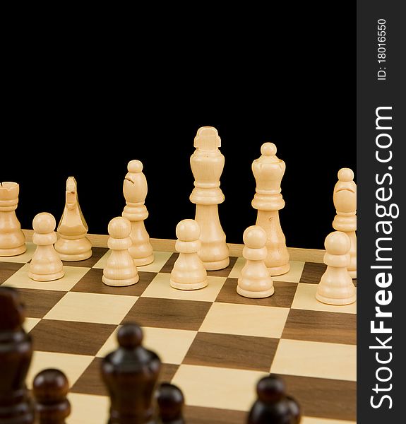 Chess piece on board isolated on black background