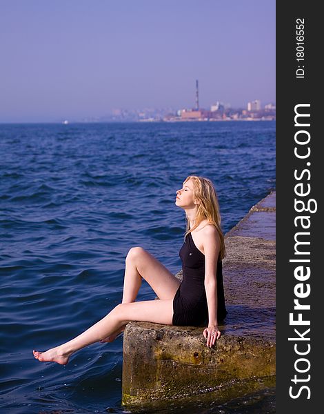 Blonde woman sitting on ruins