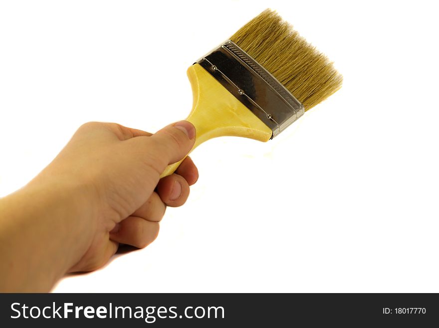 Close-up of hand with brush on whte background