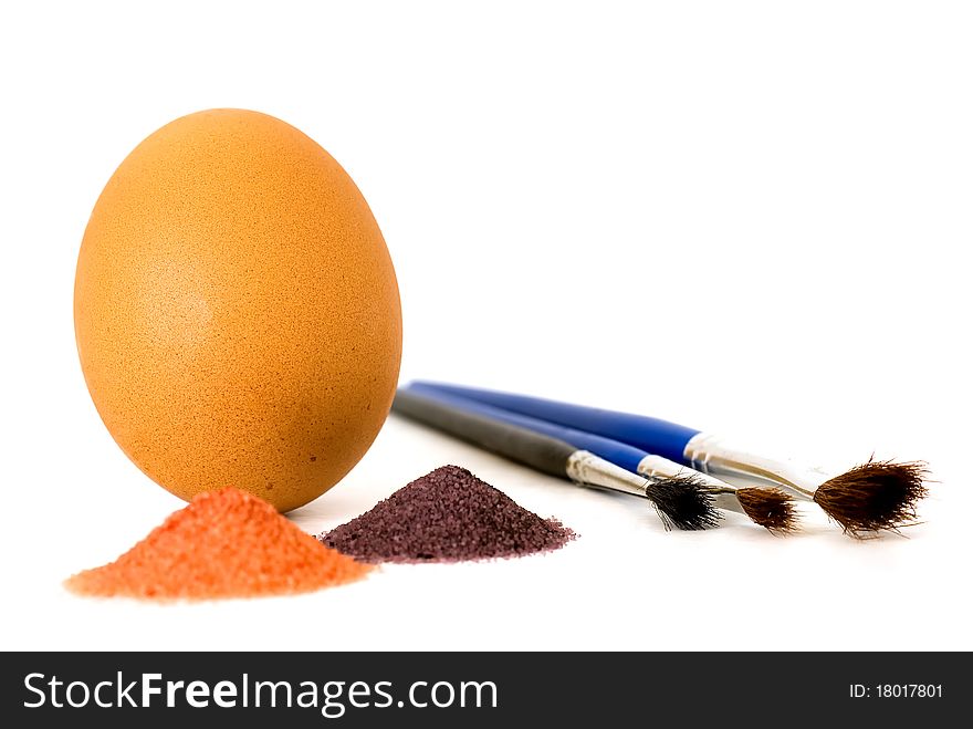 Easter accessories: egg, brushes and paint powders isolated on white background.