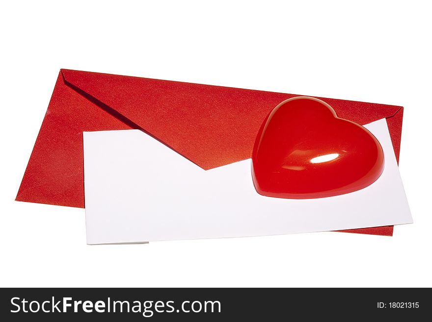 Red heart laying next to a red envelope with white paper on a white background. Red heart laying next to a red envelope with white paper on a white background.