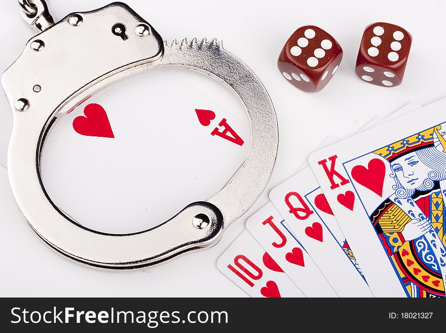 Handcuffs with things gaming - playing cards on a white background.