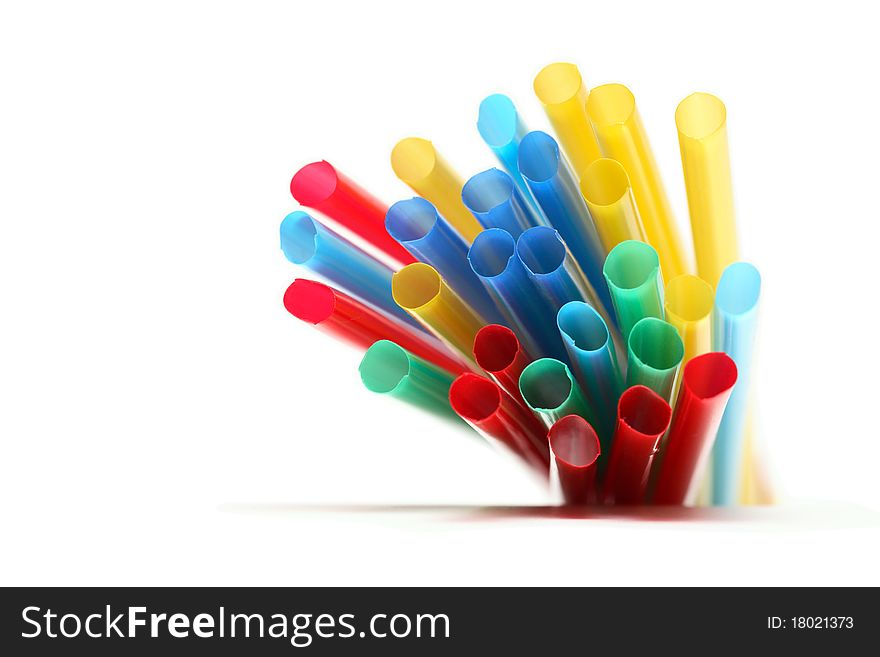 Lot of multicolored drinking straws on white background