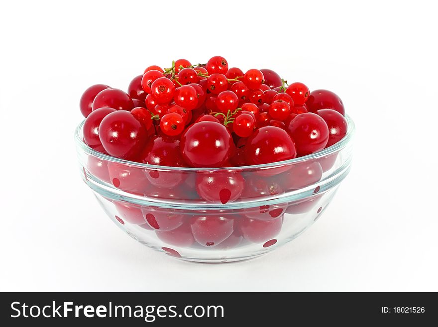 Sweet cherry and red currants in glass bowl isolated on white. Sweet cherry and red currants in glass bowl isolated on white